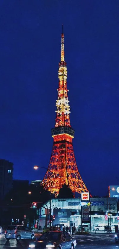 Tokyo Tower illuminated at night against a dark city skyline.