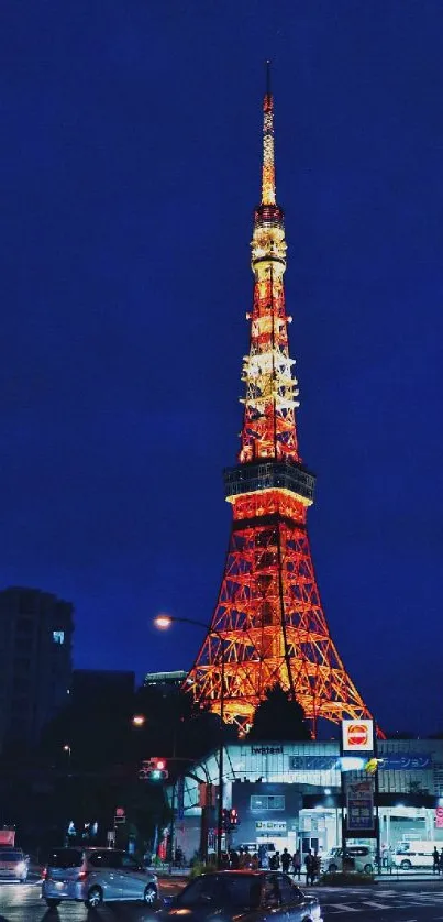 Tokyo Tower illuminated at night in vibrant city skyline.