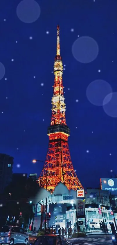 Tokyo Tower glowing at night against dark blue sky, city lights below.