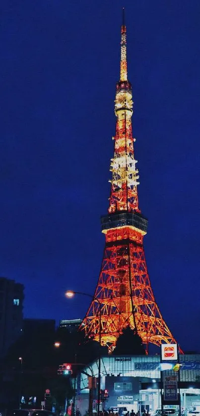 Tokyo Tower illuminated against a navy blue sky at night.