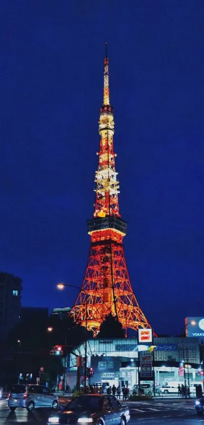 Night view of Tokyo Tower glowing against a dark city backdrop.