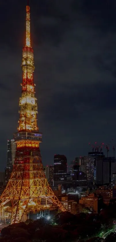 Tokyo Tower lit up at night, shining brightly in the city skyline.