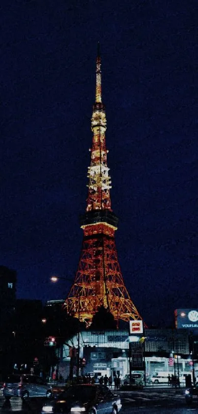 Tokyo Tower at night with city lights and dark sky.