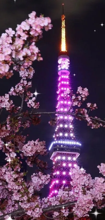 Tokyo Tower glowing behind cherry blossoms at night.