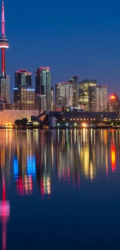 Toronto skyline reflecting on water at night.