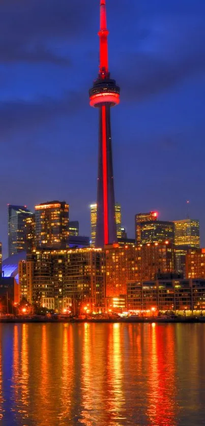 Night view of Toronto skyline and CN Tower reflected over water.