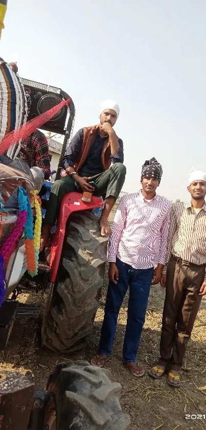 People standing by a colorful tractor in a field.