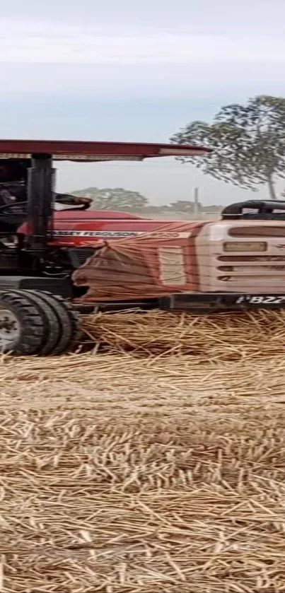 Tractor working in a hay field under a clear sky.