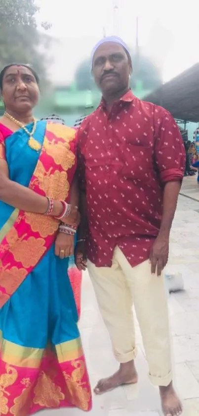 Couple in traditional Asian attire with vibrant colors.