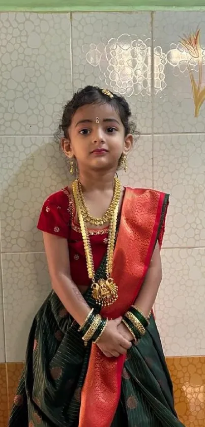 Young girl in traditional attire with ornate jewelry and vibrant colors.