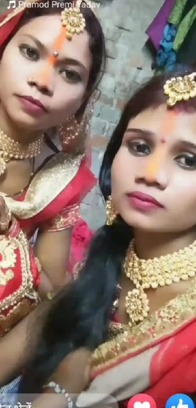 Two women in traditional attire and gold jewelry, vibrant cultural style.