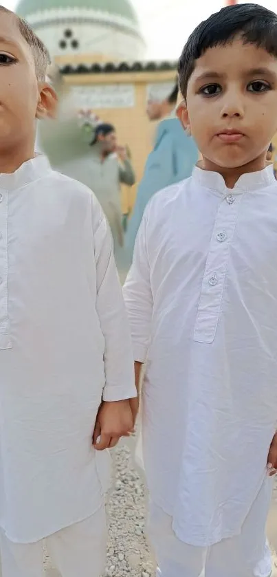 Two children in traditional white attire.