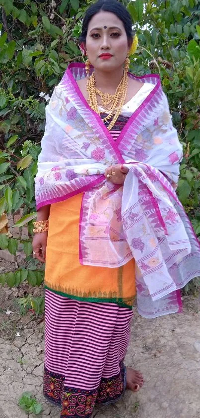 Assamese woman in traditional attire with vibrant colors and nature background.