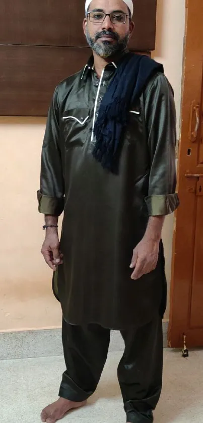 Traditional attire man posing indoors.