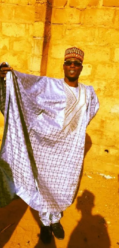 Man in traditional attire under golden sunlight casting shadows.