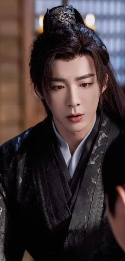 Person in traditional Asian attire looking thoughtful indoors.