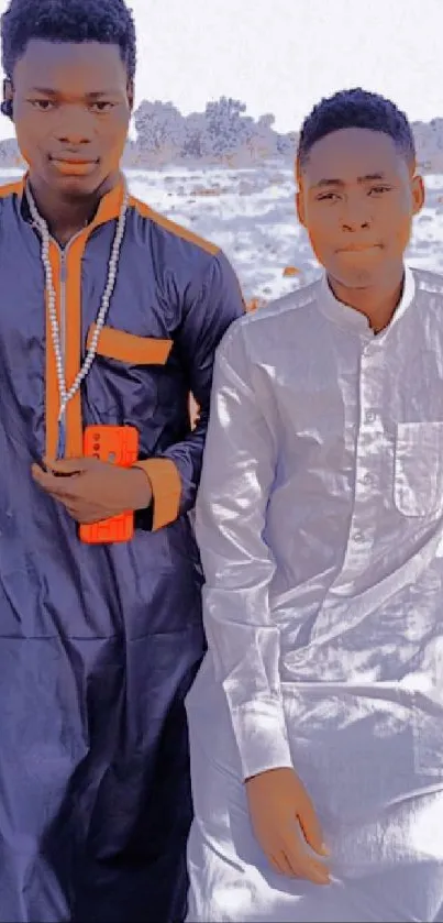 Two individuals in stylish traditional attire on a natural background.