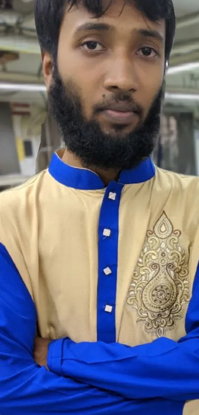 Portrait of a person in traditional blue attire with intricate design.