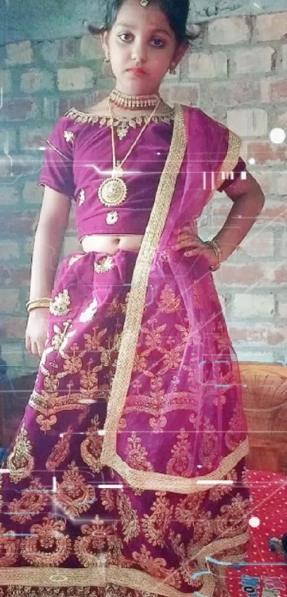 Young girl in traditional Indian attire against brick wall.