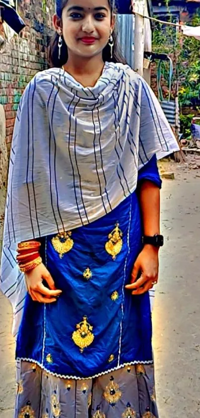 Woman in traditional attire standing outdoors.