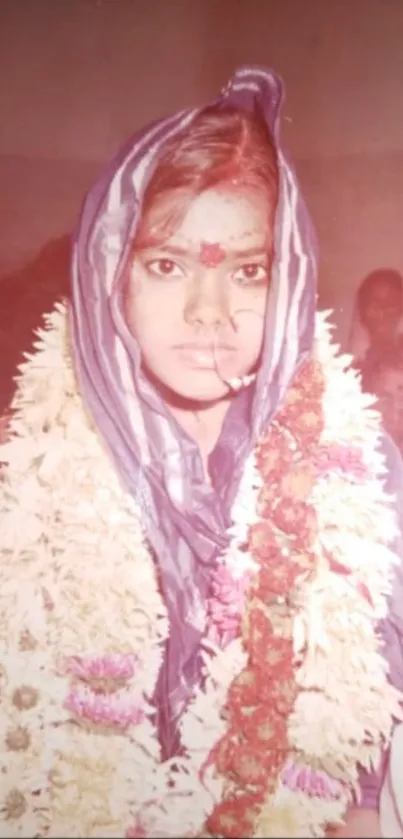 Vintage photo of a traditional bride adorned with flowers and jewelry.