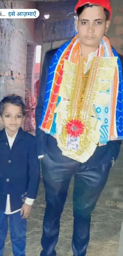 Portrait of a person and child in festive attire with colorful decorations.