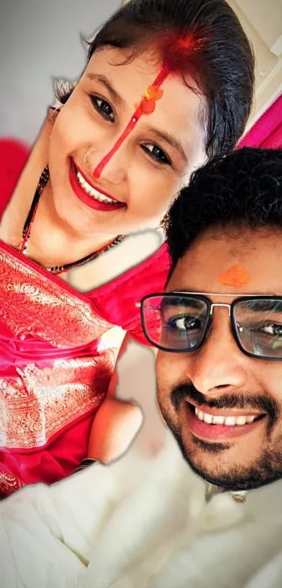 Smiling couple in traditional attire with vibrant colors.