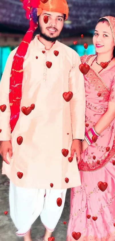 Couple in traditional Indian attire with hearts.