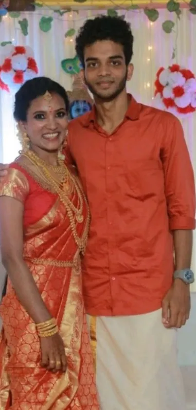 Duo wearing traditional attire with festive decorations.