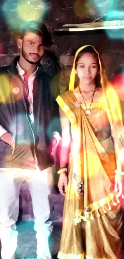 Young couple in traditional attire with a rustic backdrop.