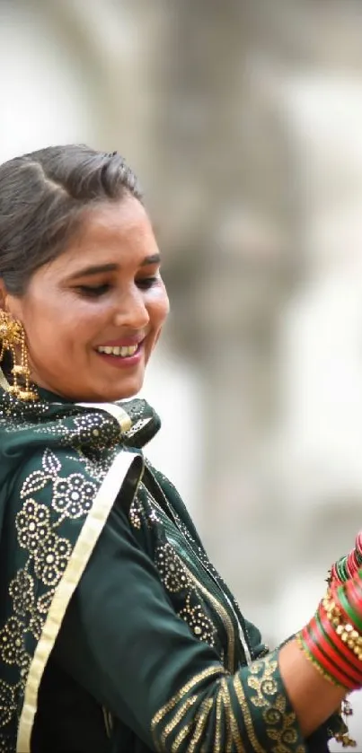 Woman in traditional attire smiling, adorned with jewelry and patterns.