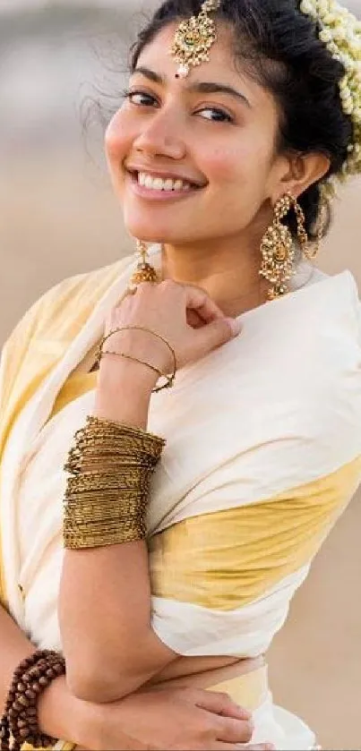 Woman in traditional attire smiling by the beach.