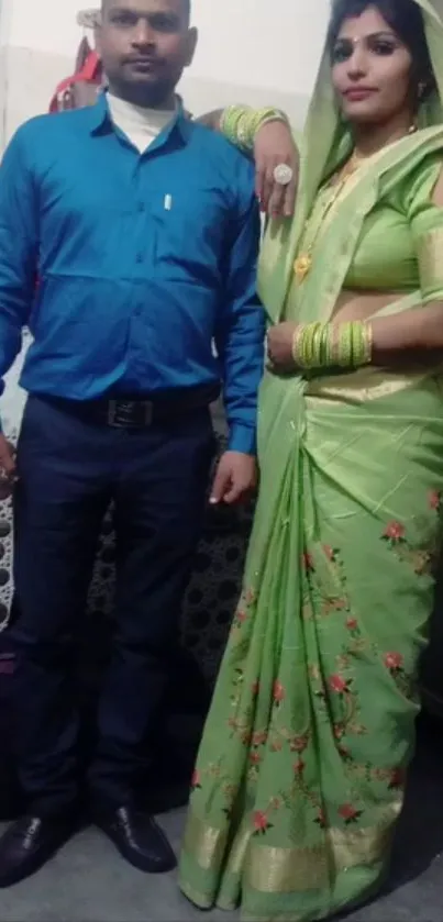 Couple posing in traditional attire with vibrant colors.