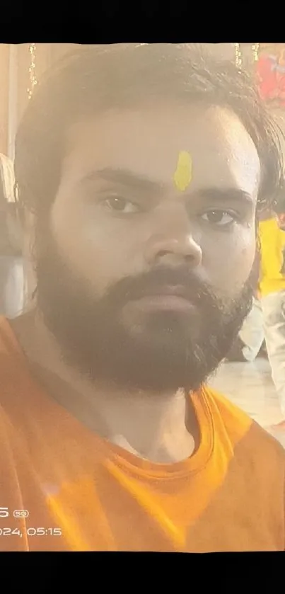 A man in traditional attire at a festival with vibrant colors.