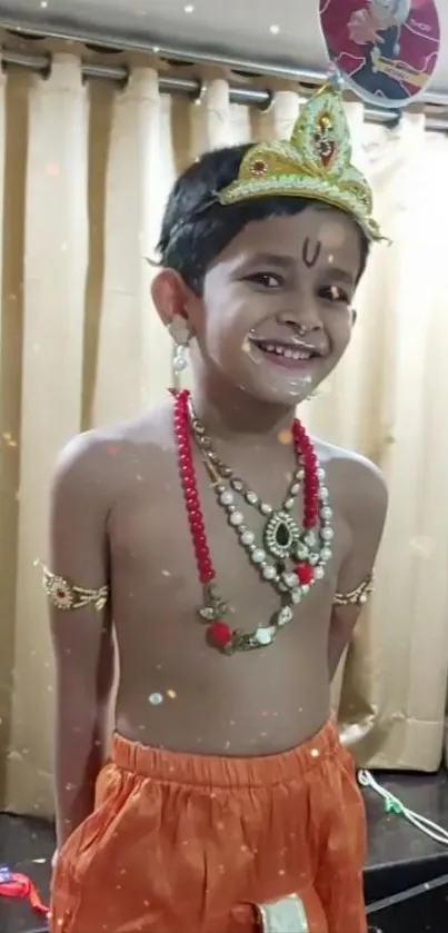 Child in traditional attire smiling brightly.