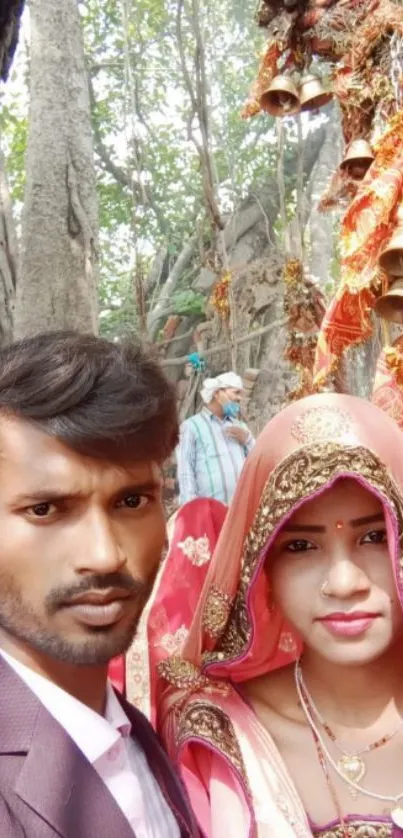 Couple in traditional attire, festive background.