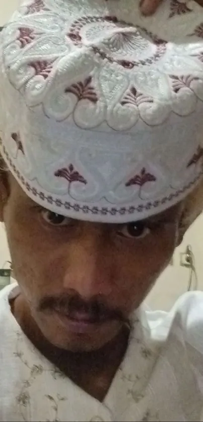 Close-up of person in traditional attire and headwear.