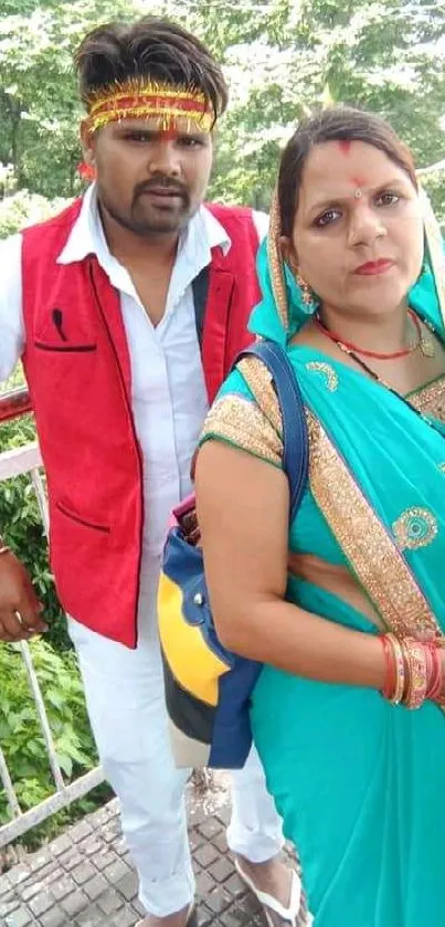 Couple in traditional Indian attire with green background.