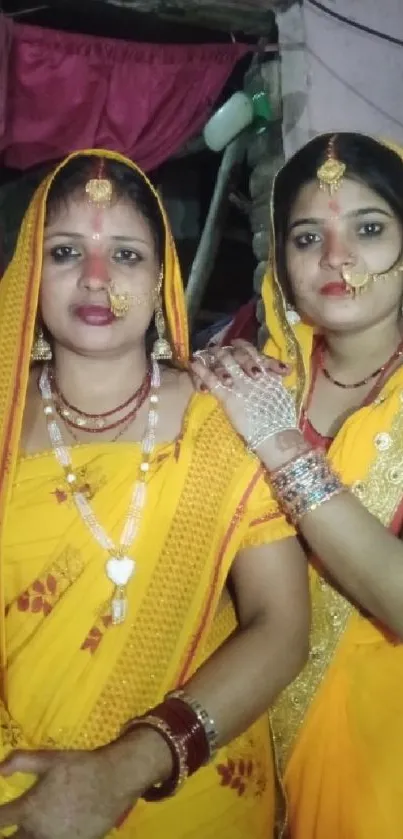 Two women in traditional Indian attire with vibrant colors and jewelry.