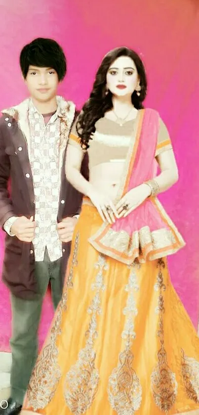 Couple in traditional Indian attire on a vibrant pink background.