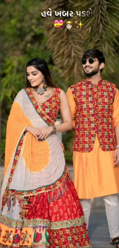 Couple in vibrant traditional Indian attire with colorful background.