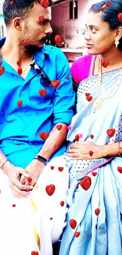 Traditional Indian couple in cultural attire with vibrant colors and a scenic village backdrop.