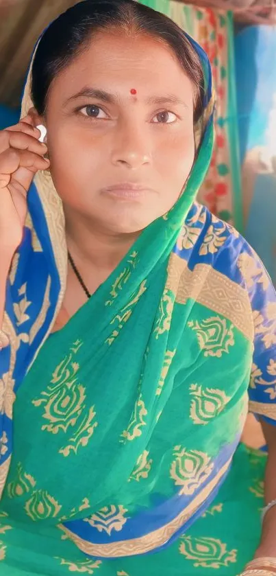 Woman in traditional green sari, vibrant cultural wallpaper.