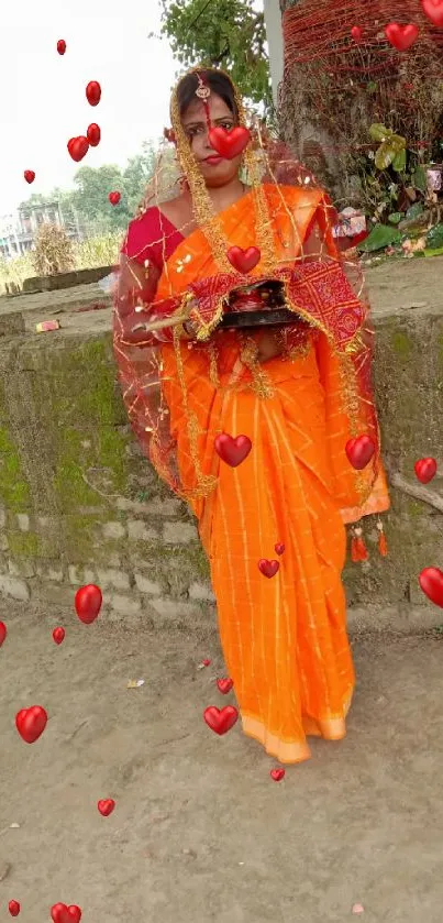 Indian woman in orange sari with ritual items.