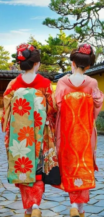 Two women in colorful kimonos walking in a traditional Japanese garden.