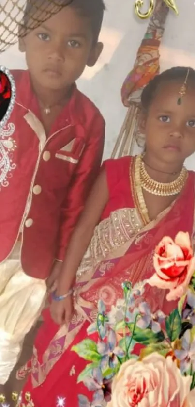 Children in traditional red attire with floral accents.