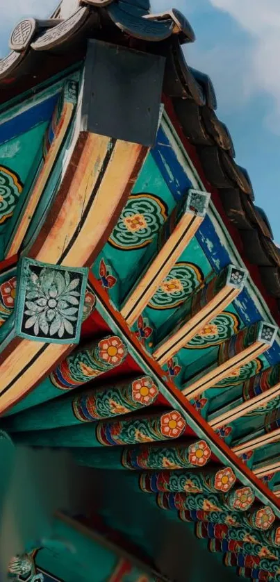 Colorful Korean traditional roof detail against a blue sky.