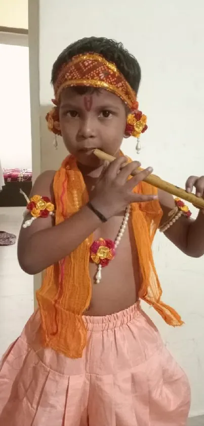 Child in Krishna costume playing flute, vibrant attire.