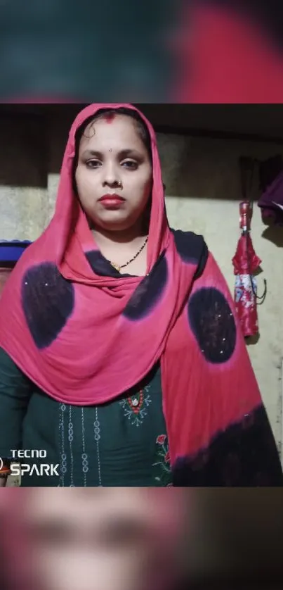 Woman in a red shawl with traditional decor background.