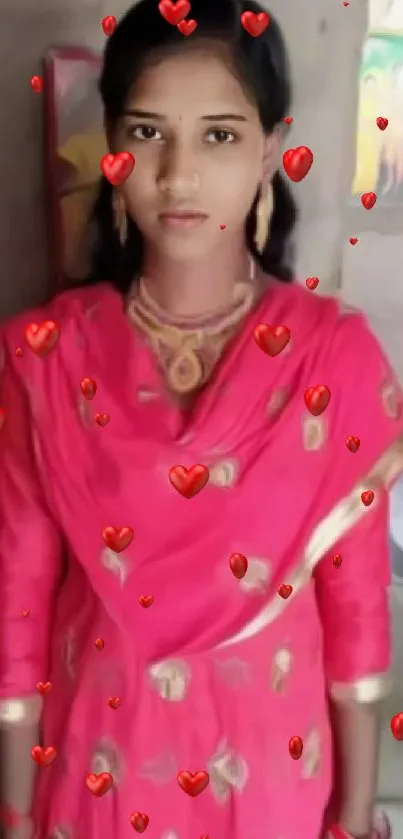 Woman in traditional pink attire with gold detailing.